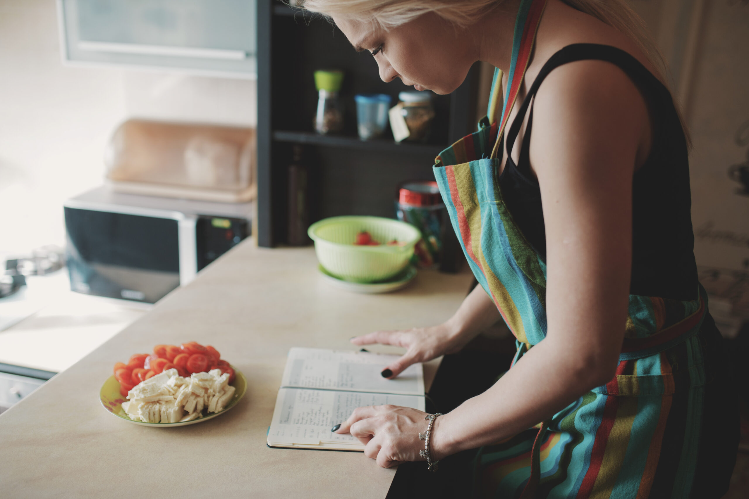 young woman looking up recipes book scaled
